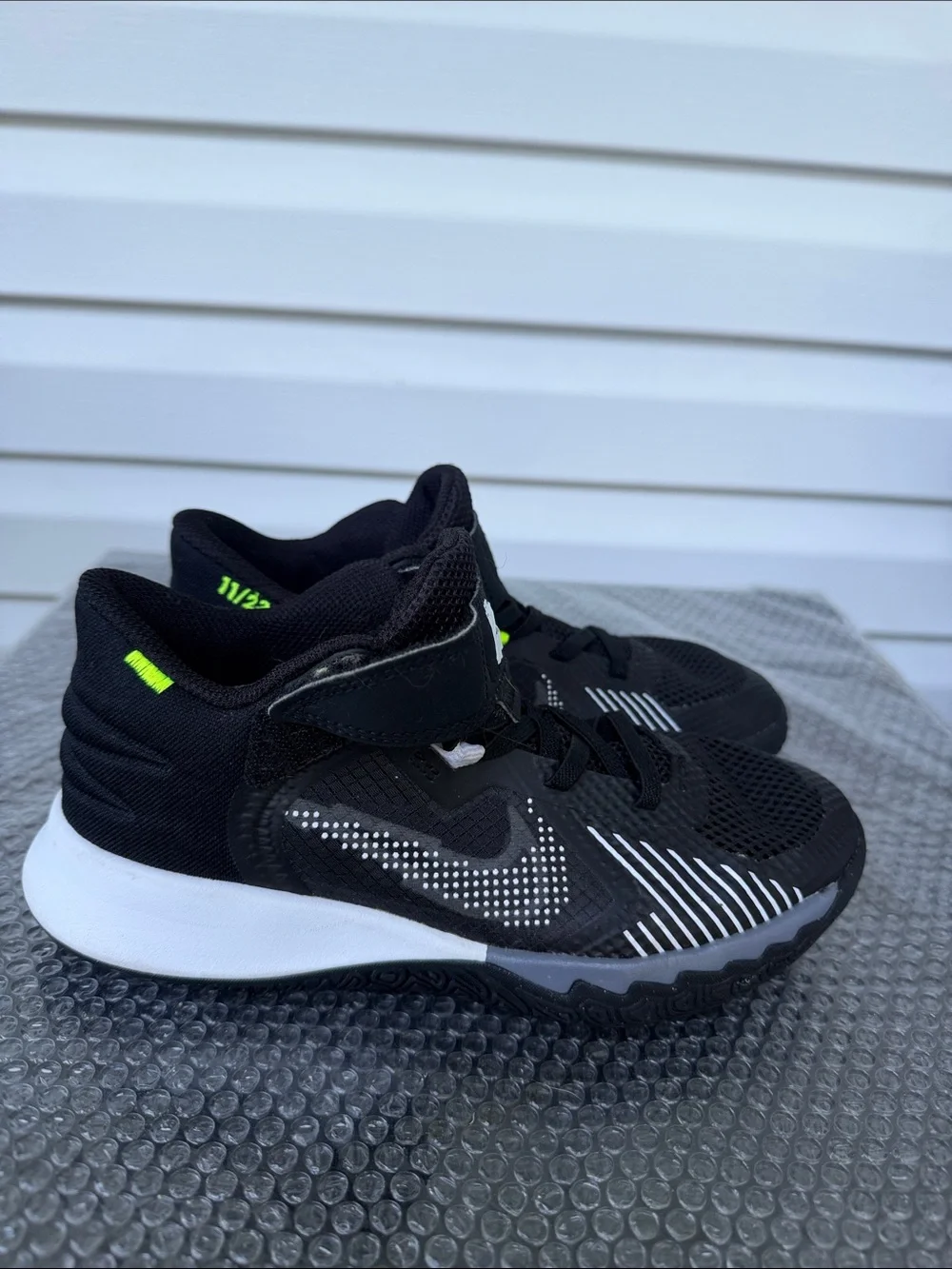 Nike Kids Black and White High-Top Sneakers with Neon Accent